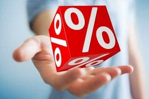 Businessman on blurred background using white and red sales flying icons 3D rendering
