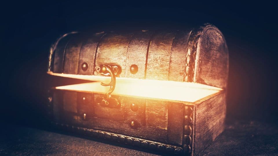 Magic wooden box with glowing light. Ancient mysterious chest. Precious antique box.